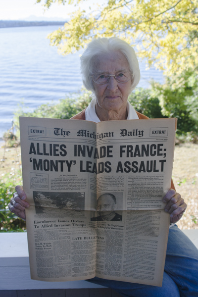 Claire Thomas holds a copy of The Michigan Daily from June 6, 1944. She was editor of the paper during the D-Day invasion of Europe. 