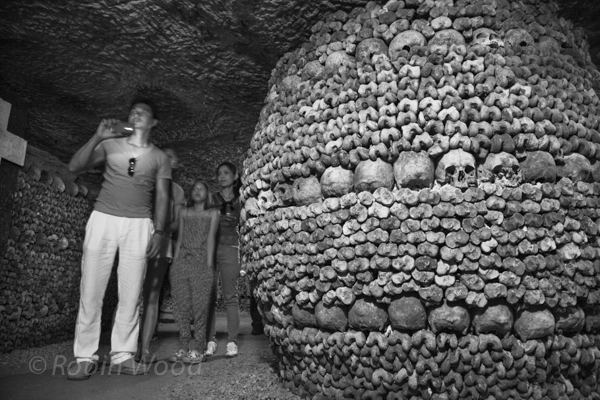A family with surprisingly young children work their way through the catacombs. 